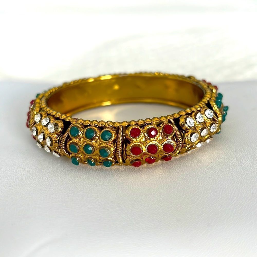 Goldstone bangle bracelet with inset colored stones